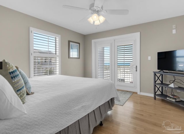 bedroom with access to outside, ceiling fan, and light wood-type flooring