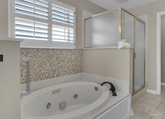 bathroom featuring tile patterned flooring and shower with separate bathtub