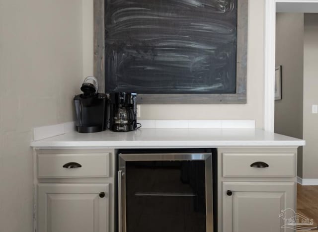 bar with wine cooler and white cabinets