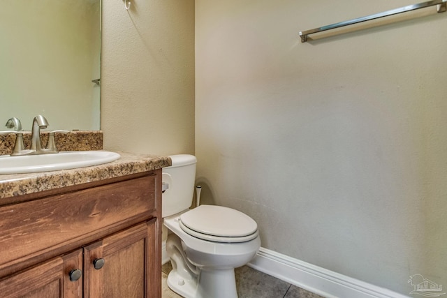 bathroom featuring vanity, tile patterned flooring, and toilet