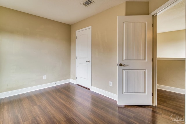 unfurnished bedroom featuring dark wood-type flooring