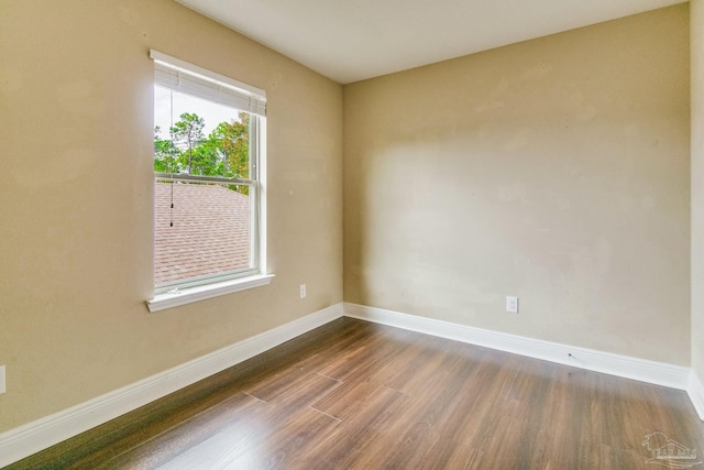 spare room with dark hardwood / wood-style floors