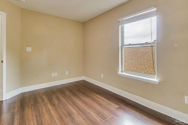 spare room featuring dark wood-type flooring