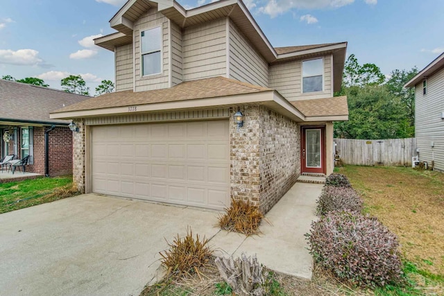 view of front of house with a garage and a front yard