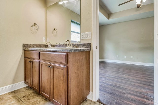 bathroom with ceiling fan, vanity, and hardwood / wood-style floors