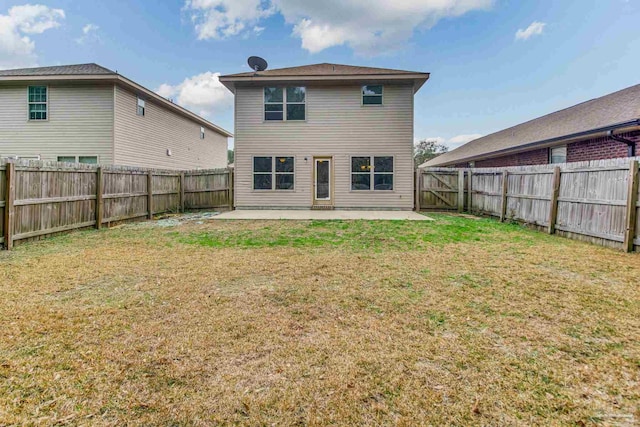 back of house with a yard and a patio area