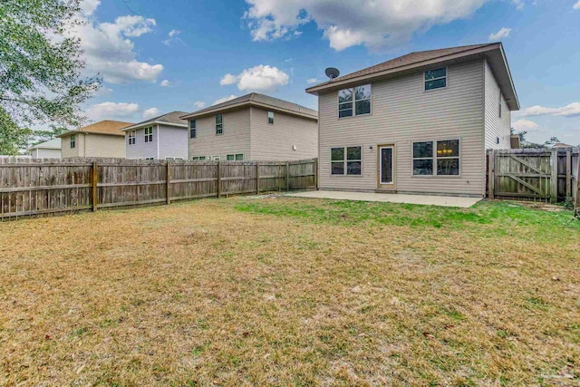 back of property featuring a patio and a lawn