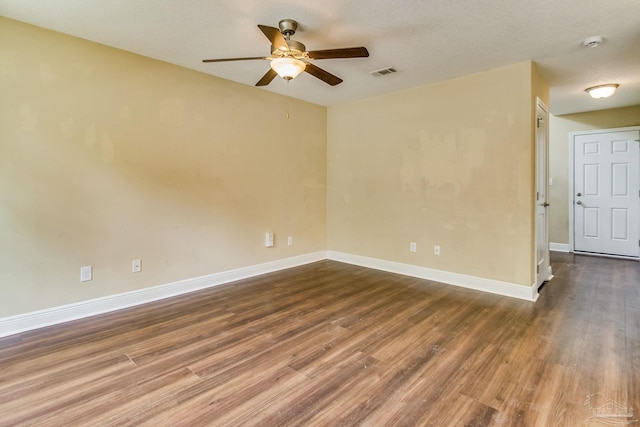 unfurnished room featuring ceiling fan and dark hardwood / wood-style flooring