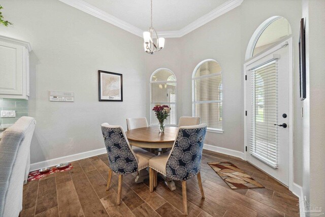 1328 Tour Dr, Gulf Breeze, FL 32563 - dining room featuring crown molding, wood finished floors, baseboards, and a chandelier