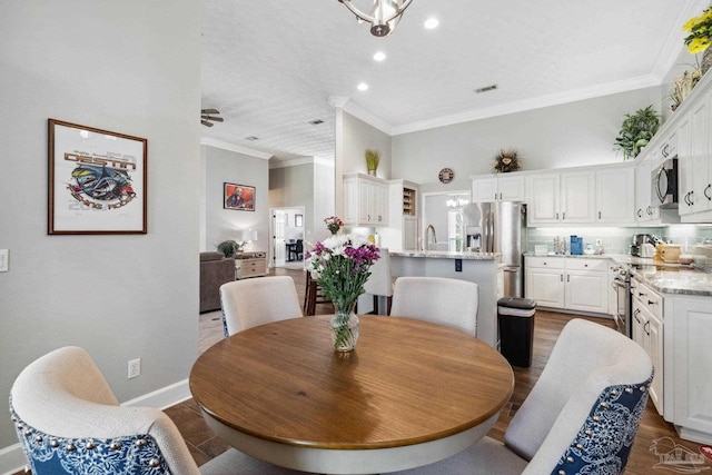 1328 Tour Dr, Gulf Breeze, FL 32563 - dining area with ornamental molding, recessed lighting, baseboards, and dark wood-style floors