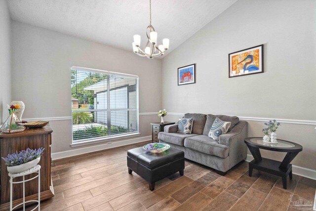 1328 Tour Dr, Gulf Breeze, FL 32563 - living room with a chandelier, lofted ceiling, wood finished floors, baseboards, and a textured ceiling