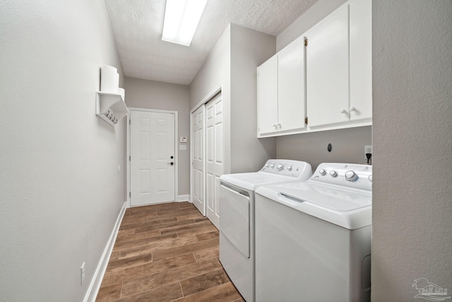 1328 Tour Dr, Gulf Breeze, FL 32563 - laundry area with cabinet space, washing machine and dryer, dark wood finished floors, baseboards, and a textured ceiling