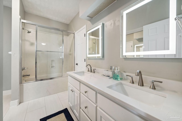 1328 Tour Dr, Gulf Breeze, FL 32563 - bathroom with bath / shower combo with glass door, double vanity, and tile patterned floors