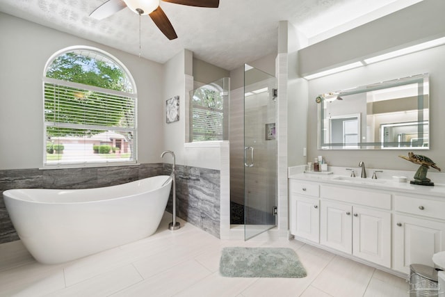 1328 Tour Dr, Gulf Breeze, FL 32563 - full bathroom with ceiling fan, vanity, a freestanding bath, a stall shower, and tile patterned floors