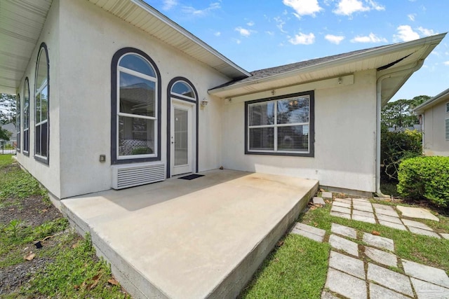 1328 Tour Dr, Gulf Breeze, FL 32563 - back of house featuring stucco siding and a patio area