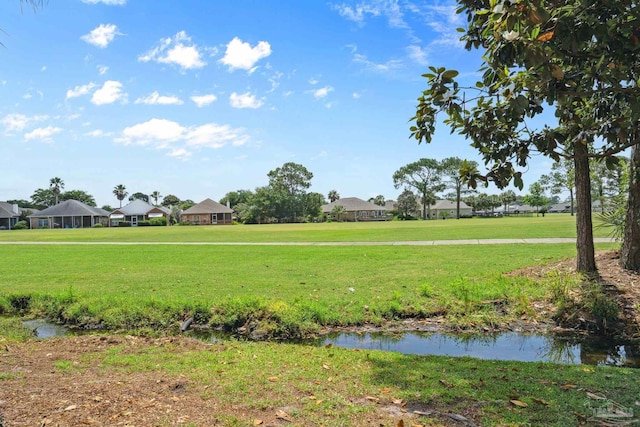 1328 Tour Dr, Gulf Breeze, FL 32563 - view of property's community featuring a lawn and a residential view