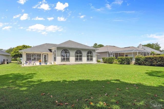 1328 Tour Dr, Gulf Breeze, FL 32563 - rear view of house with a lawn and stucco siding