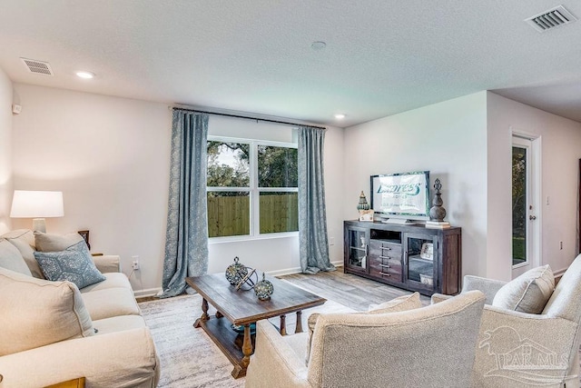 6340 Firefly Dr, Milton, FL 32583 - living area featuring recessed lighting, a textured ceiling, visible vents, and wood finished floors