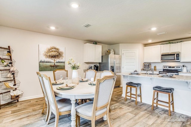 6340 Firefly Dr, Milton, FL 32583 - dining area featuring visible vents, recessed lighting, light wood finished floors, and baseboards