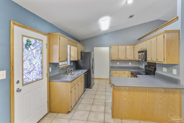 kitchen featuring light tile patterned floors, stainless steel appliances, vaulted ceiling, kitchen peninsula, and light brown cabinets