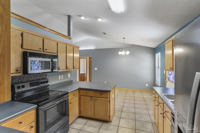 kitchen featuring light tile patterned floors, stainless steel appliances, a notable chandelier, vaulted ceiling, and kitchen peninsula