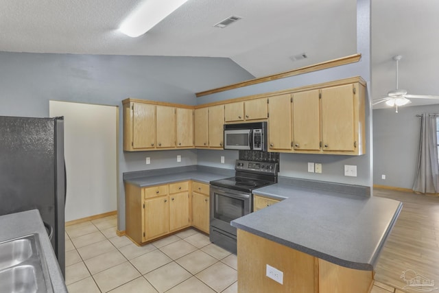 kitchen featuring stainless steel range with electric stovetop, refrigerator, vaulted ceiling, kitchen peninsula, and ceiling fan