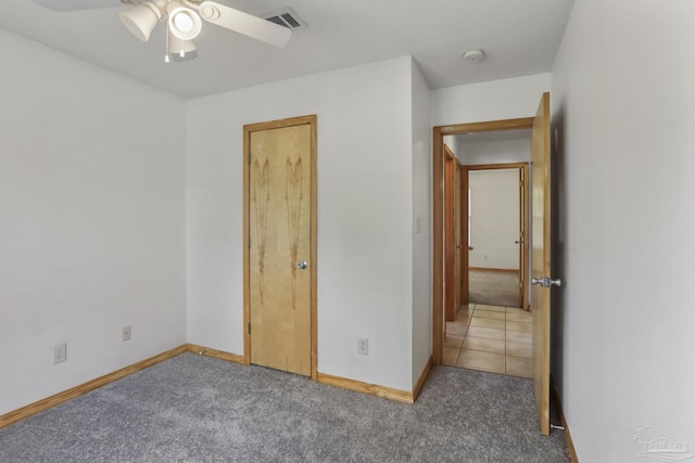 unfurnished bedroom featuring ceiling fan and carpet flooring