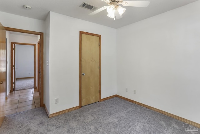 unfurnished room featuring light carpet and ceiling fan