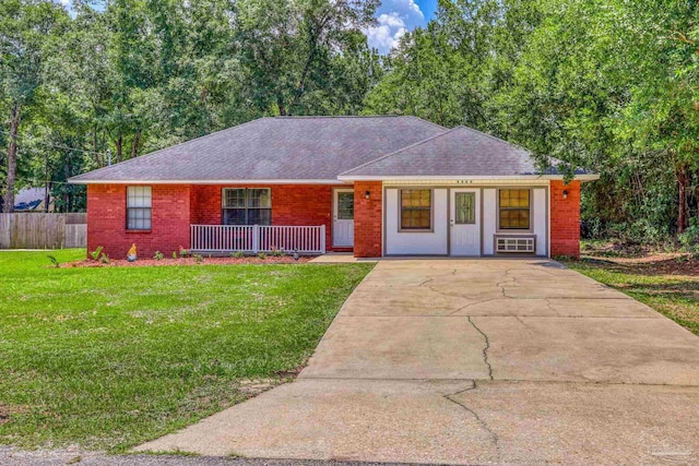 ranch-style home featuring a porch and a front yard