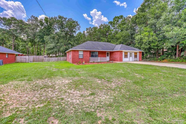 ranch-style home with covered porch and a front yard