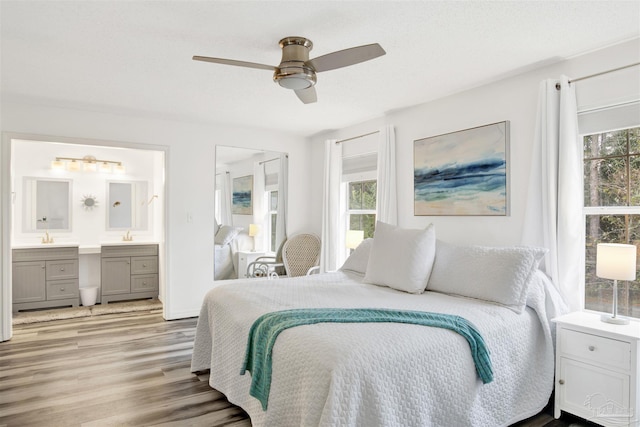 3228 Birdseye Cir, Gulf Breeze, FL 32563 - bedroom featuring multiple windows, wood finished floors, ensuite bath, and a ceiling fan