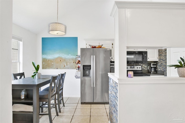 kitchen with backsplash, light tile patterned floors, decorative light fixtures, white cabinetry, and stainless steel appliances