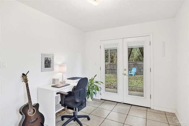 home office with french doors, light tile patterned floors, and a textured ceiling