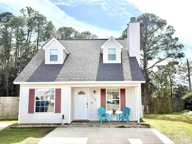 3228 Birdseye Cir, Gulf Breeze, FL 32563 - cape cod-style house with a porch, a chimney, and a shingled roof