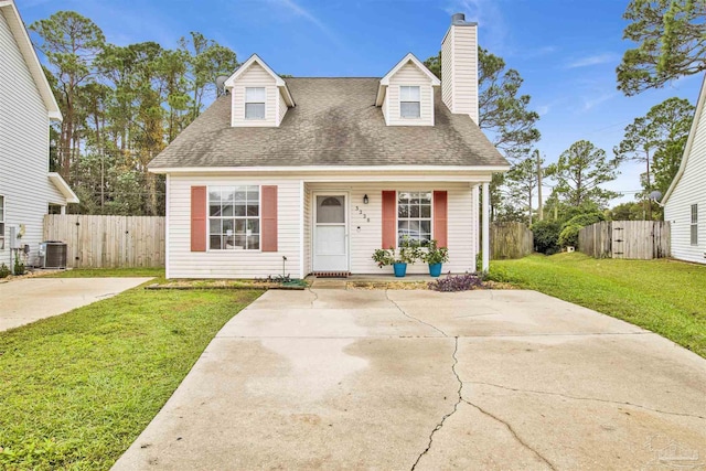 cape cod home featuring a front lawn and central AC