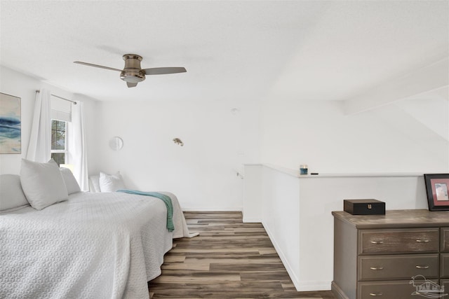 bedroom featuring vaulted ceiling with beams, ceiling fan, and dark wood-type flooring