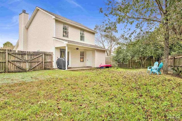 3228 Birdseye Cir, Gulf Breeze, FL 32563 - rear view of property featuring a chimney, a patio, and a fenced backyard