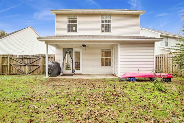 back of house featuring a lawn, a patio area, and ceiling fan