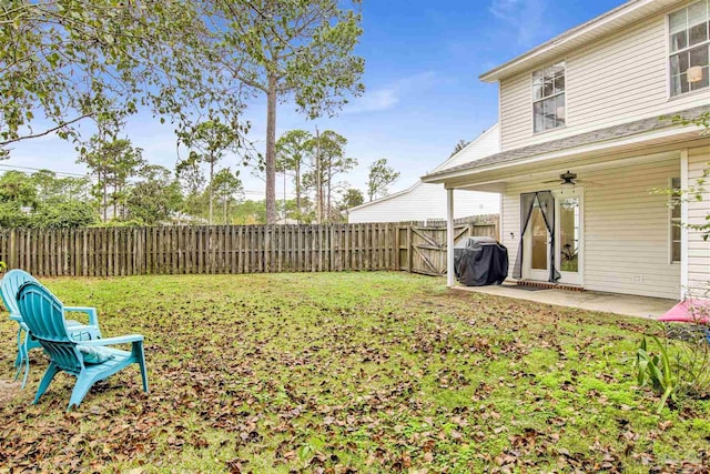 view of yard featuring ceiling fan and a patio area