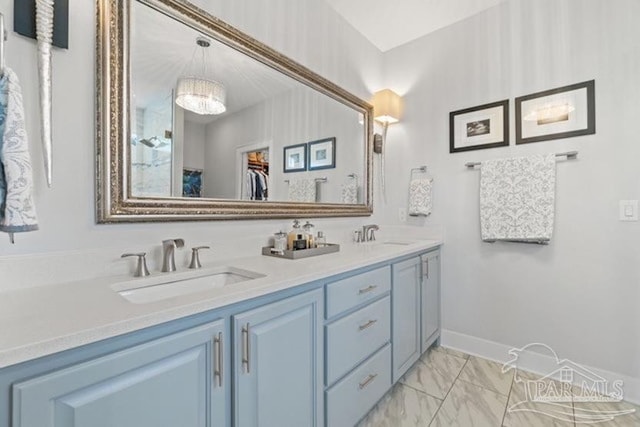 bathroom with vanity and an inviting chandelier