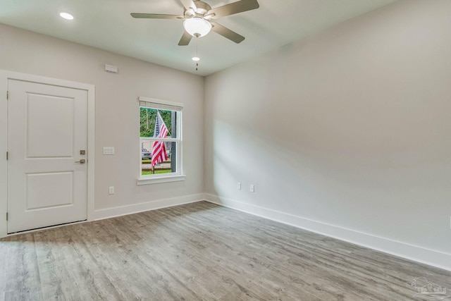 spare room with light hardwood / wood-style floors and ceiling fan