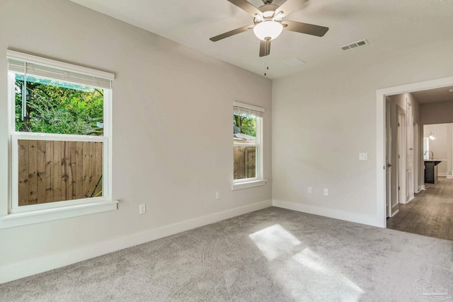 empty room featuring carpet flooring and ceiling fan