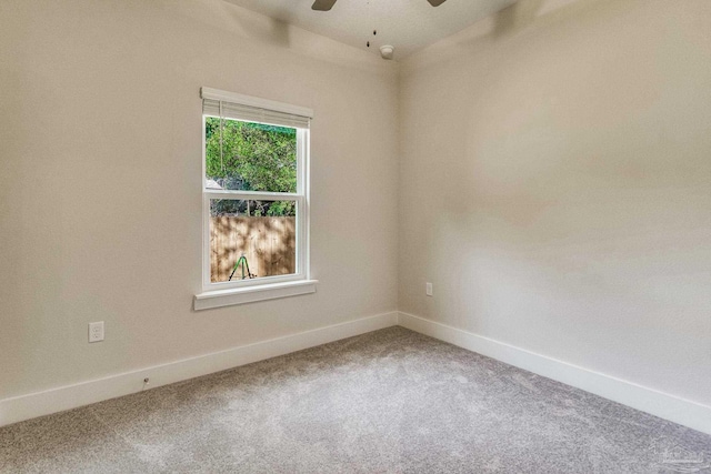 spare room featuring carpet and ceiling fan