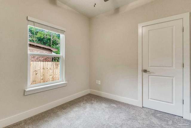 carpeted empty room featuring ceiling fan