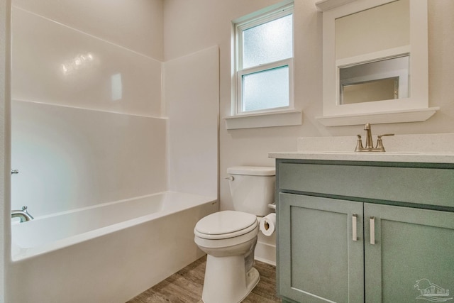 full bathroom featuring shower / bathing tub combination, toilet, vanity, and hardwood / wood-style flooring