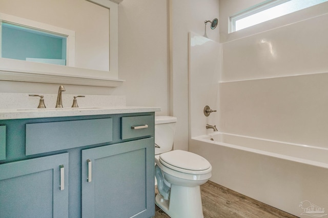 full bathroom with toilet, vanity, hardwood / wood-style flooring, and bathing tub / shower combination