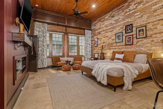 bedroom with wooden walls, ceiling fan, and wooden ceiling