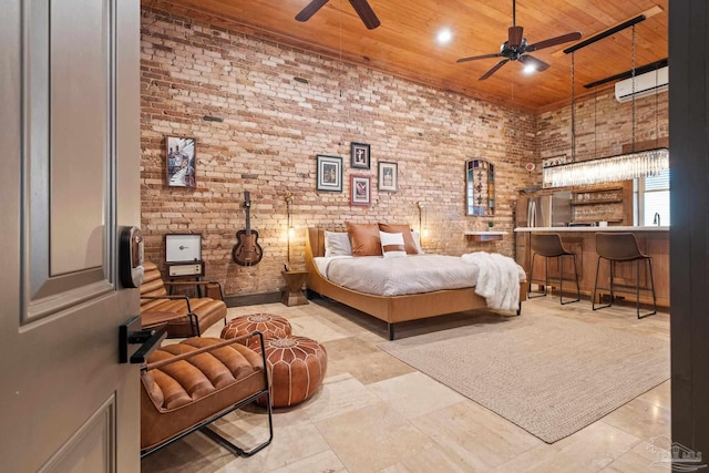 bedroom with stainless steel refrigerator, wood ceiling, a high ceiling, and brick wall