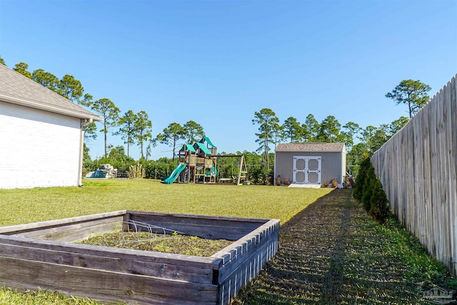 view of yard with a storage shed and a playground