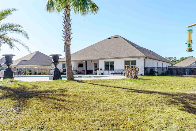 back of house featuring a fenced in pool, a yard, and a patio area